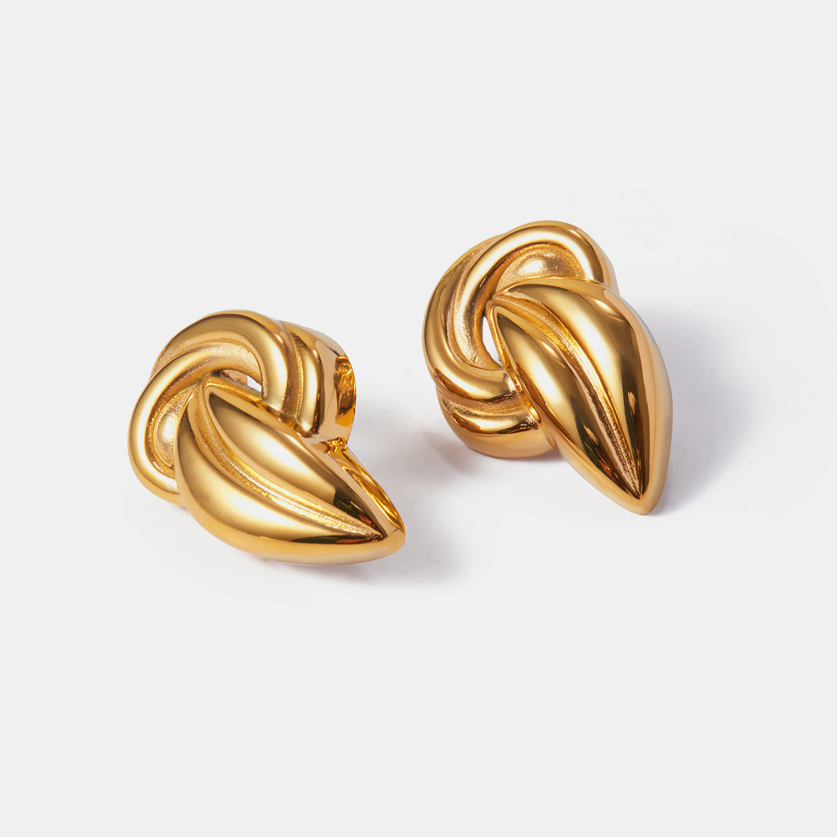 "A close-up view of earring an 18K Gold-Plated Stud Earrings. The earring features an intricate design with a twisted knot shape, adding a bold and elegant touch to the overall appearance."